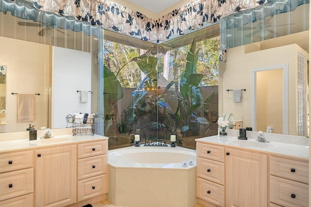 bathroom with a bathtub, vanity, and tile patterned flooring