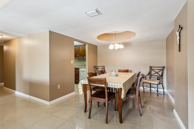 dining area featuring a notable chandelier