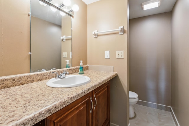 bathroom with vanity, toilet, and tile patterned floors