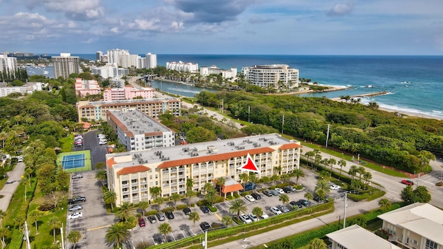 aerial view with a water view and a beach view