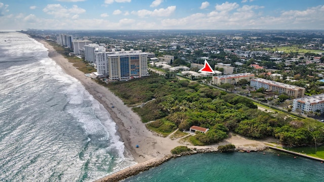 drone / aerial view featuring a beach view and a water view