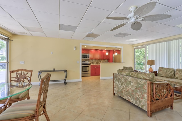 living room with ceiling fan and light tile patterned floors