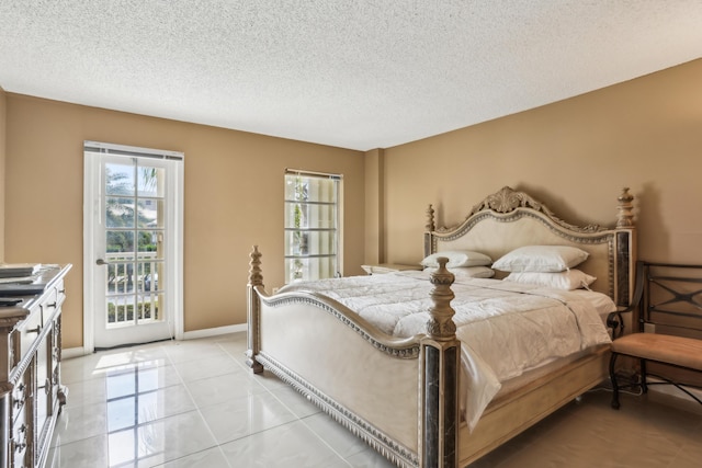 bedroom with access to outside and a textured ceiling