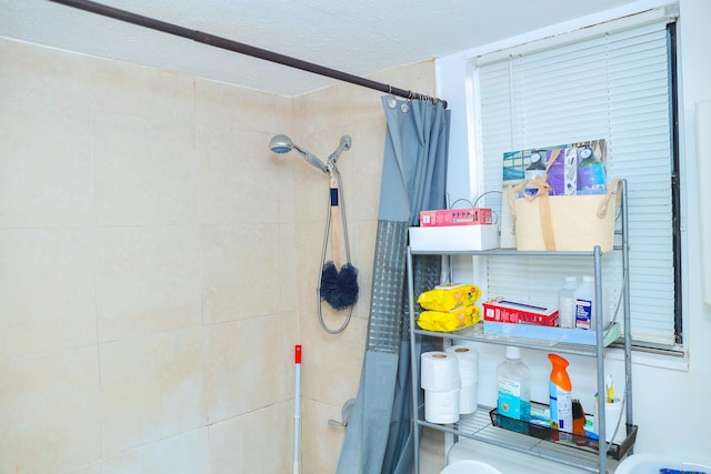 bathroom with a textured ceiling and walk in shower