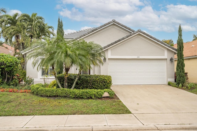 view of front facade with a garage and a front lawn