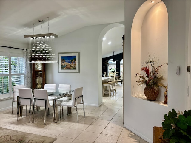 dining room with light tile patterned floors and lofted ceiling