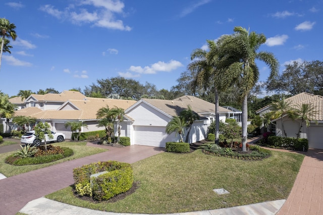 view of front of home with a garage and a front lawn