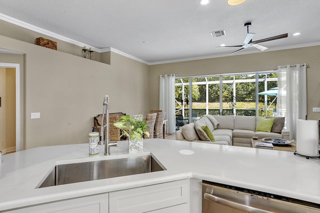 kitchen with sink, crown molding, dishwasher, ceiling fan, and white cabinets