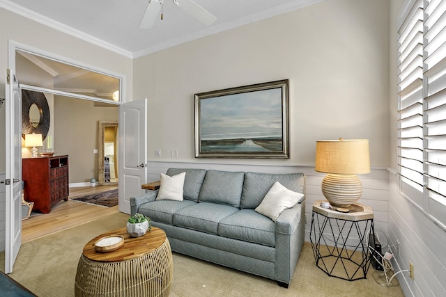 living room featuring ornamental molding, wood-type flooring, and ceiling fan