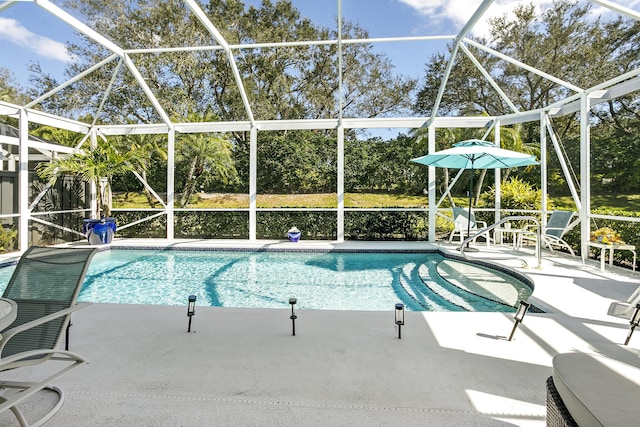 view of pool with a lanai and a patio area