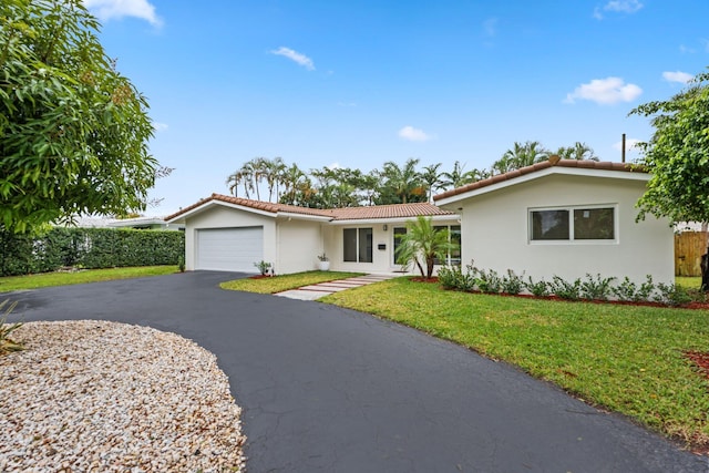 ranch-style house with a front yard and a garage