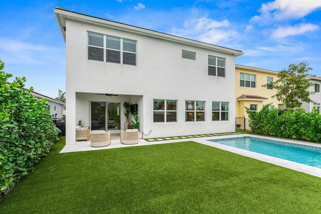 back of property with a patio area, ceiling fan, and a lawn