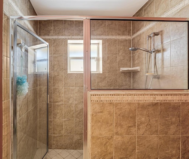 bathroom featuring a shower with shower door