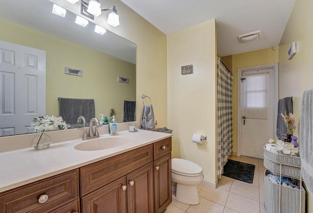 bathroom with vanity, toilet, and tile patterned flooring