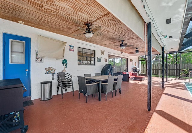 view of patio / terrace featuring ceiling fan and a lanai