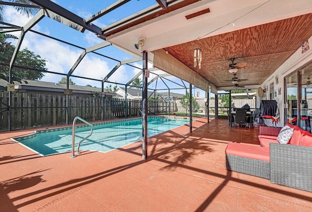 view of pool featuring a lanai, outdoor lounge area, a patio, and ceiling fan