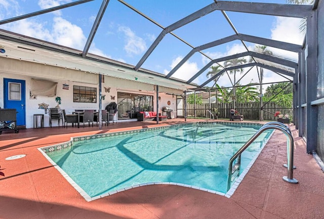 view of swimming pool featuring a patio and a lanai