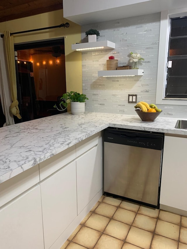 kitchen with light tile patterned flooring, white cabinets, decorative backsplash, and dishwasher