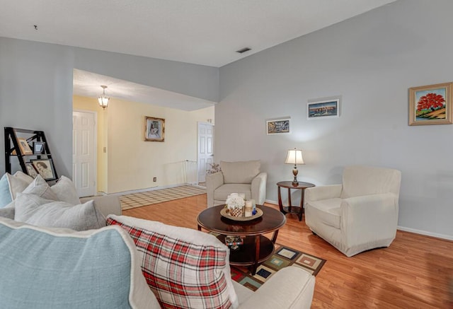 living room with lofted ceiling and light wood-type flooring