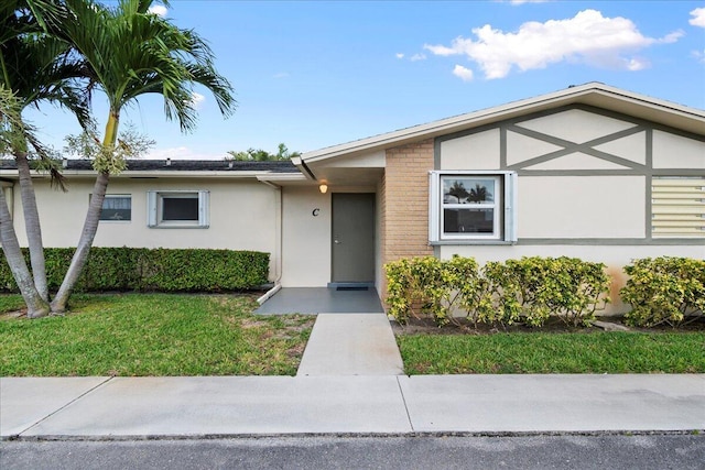 ranch-style home with a front yard