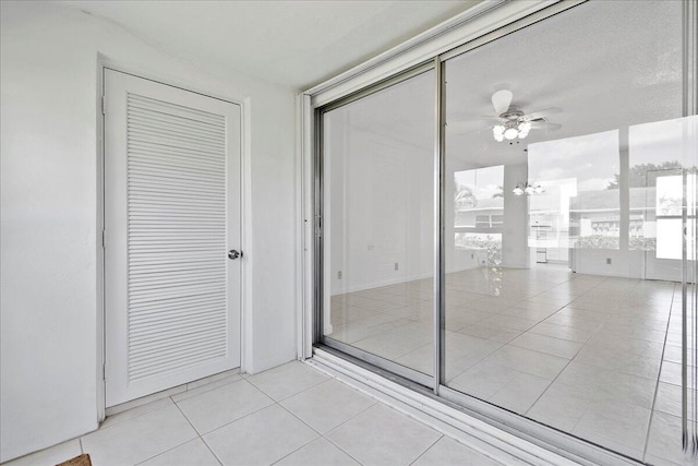 interior space with ceiling fan and tile patterned flooring