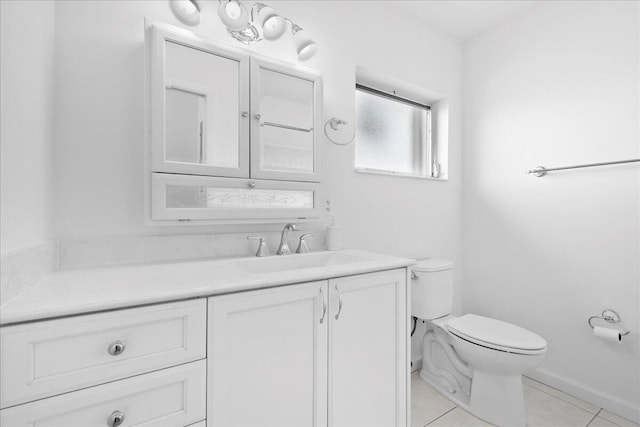 bathroom featuring toilet, tile patterned floors, and vanity