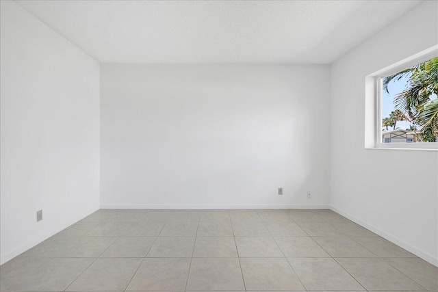 spare room with light tile patterned floors