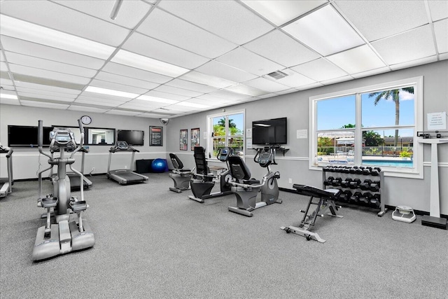 exercise room featuring plenty of natural light and a drop ceiling