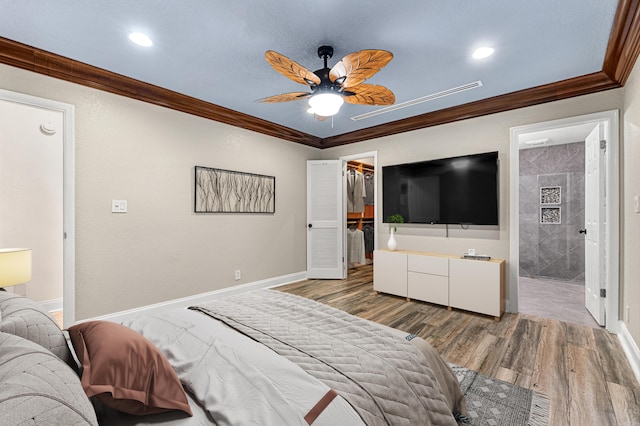 bedroom featuring crown molding, ceiling fan, wood-type flooring, a spacious closet, and a closet