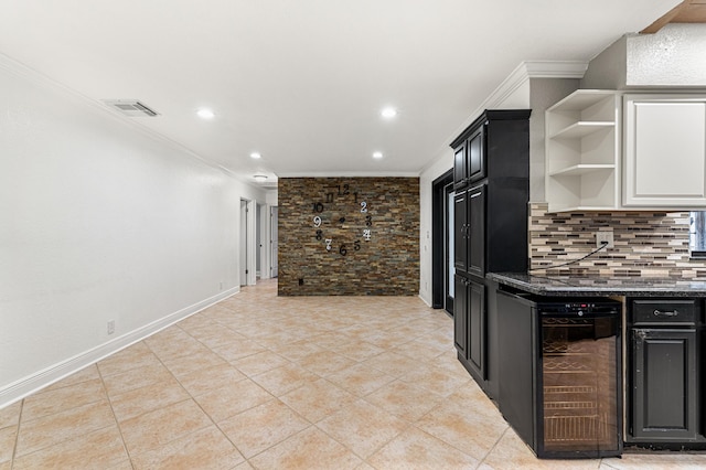 kitchen featuring light tile patterned flooring, dark stone countertops, beverage cooler, backsplash, and ornamental molding