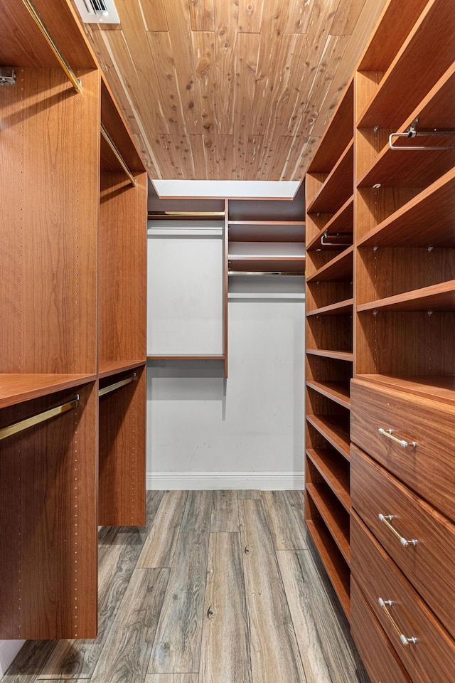 spacious closet with hardwood / wood-style flooring