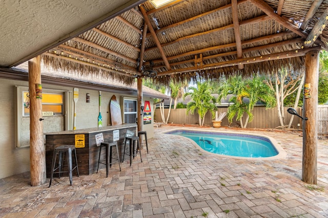 view of swimming pool with a bar, a patio, and a gazebo