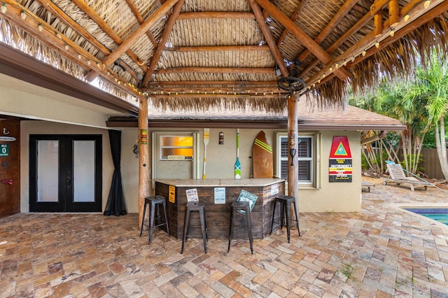 view of patio featuring french doors, a gazebo, and a bar