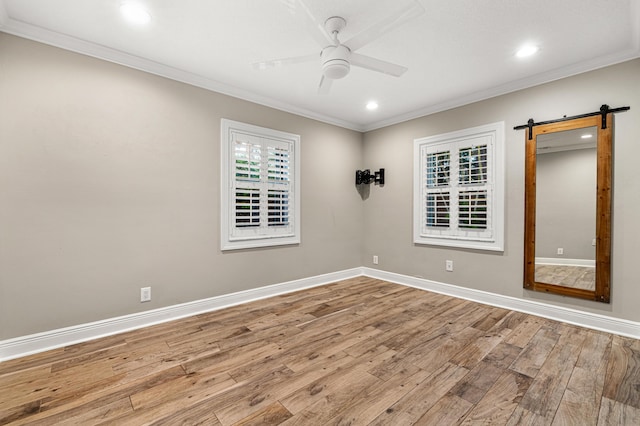 spare room featuring ceiling fan, ornamental molding, and light hardwood / wood-style floors