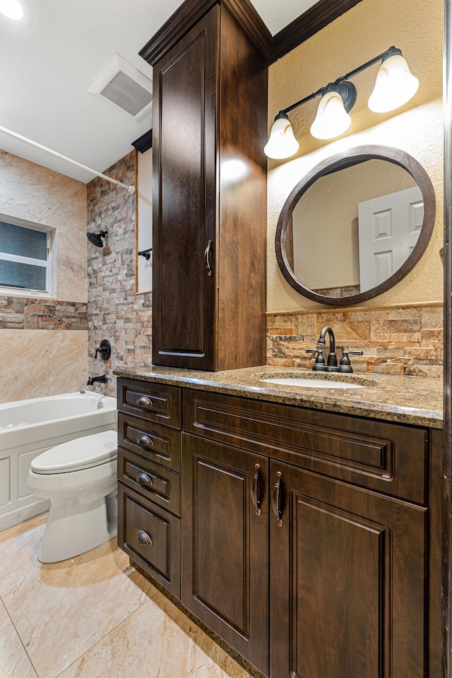 full bathroom featuring ornamental molding, bathtub / shower combination, vanity, and toilet