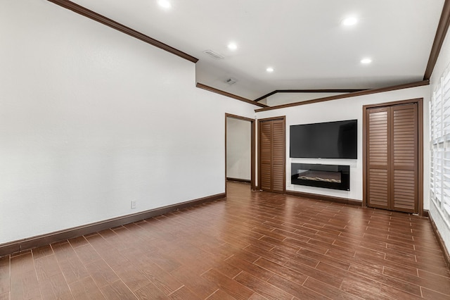 unfurnished living room with lofted ceiling and ornamental molding