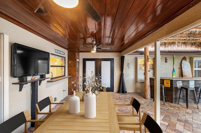 dining area featuring ornamental molding and wooden ceiling