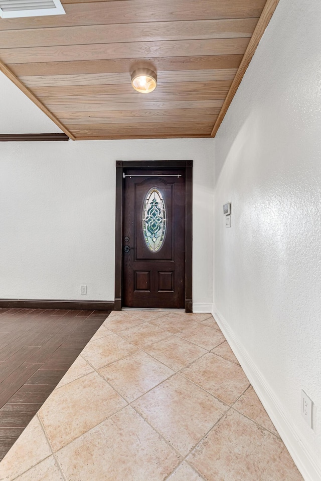 entryway featuring tile patterned flooring and wooden ceiling