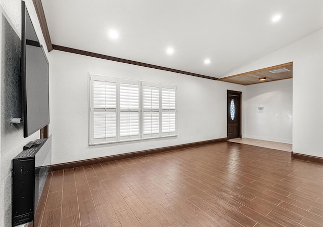 unfurnished living room featuring vaulted ceiling