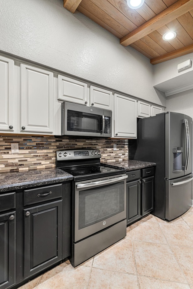 kitchen with white cabinetry, beam ceiling, tasteful backsplash, and stainless steel appliances