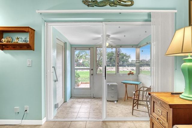 doorway to outside with ceiling fan and light tile patterned floors