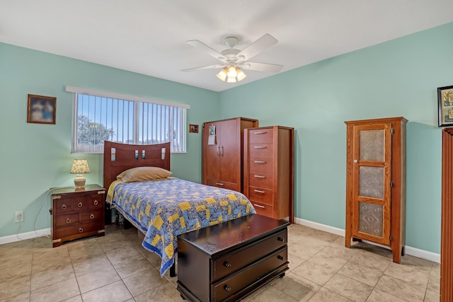 tiled bedroom with ceiling fan