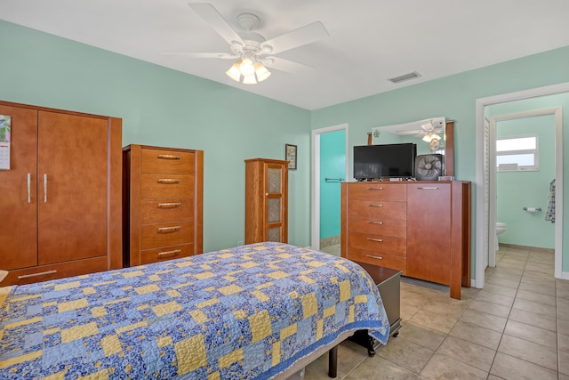 bedroom with ceiling fan, connected bathroom, and light tile patterned floors