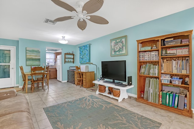 living room with ceiling fan and light tile patterned floors