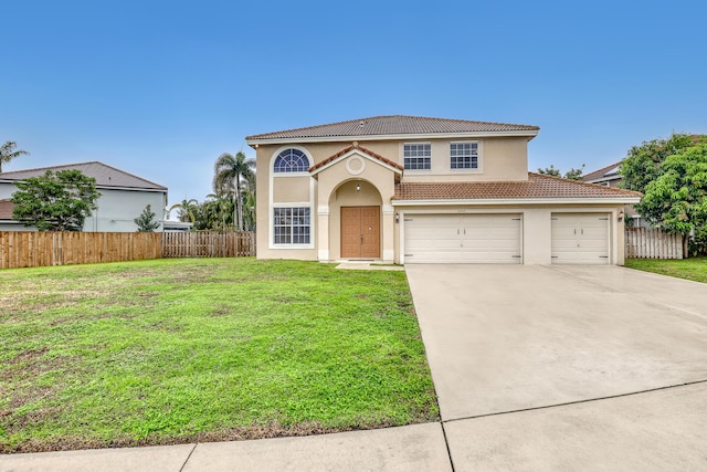 mediterranean / spanish-style house featuring a garage and a front yard