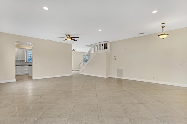 unfurnished living room with ceiling fan and light tile patterned flooring