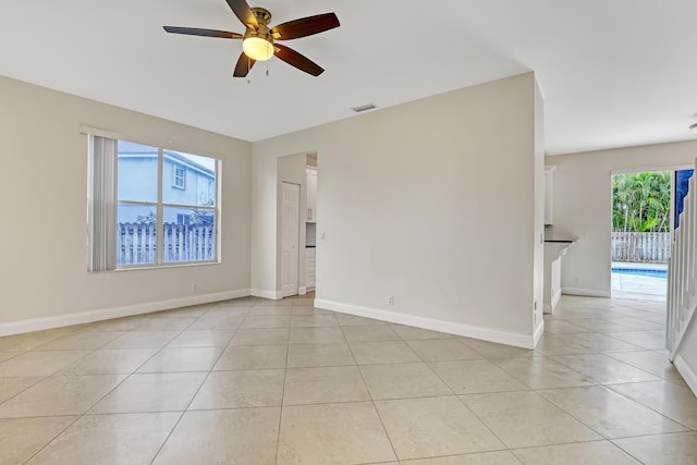 spare room with light tile patterned floors and ceiling fan