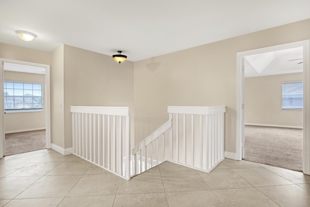 hall featuring light tile patterned floors