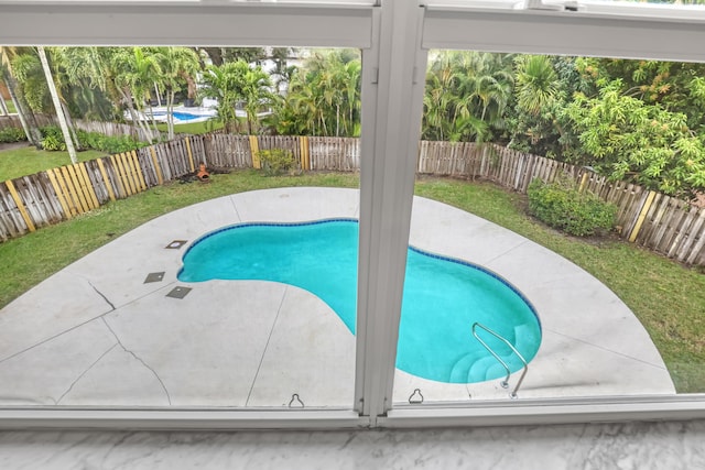 view of pool featuring a patio area and a yard