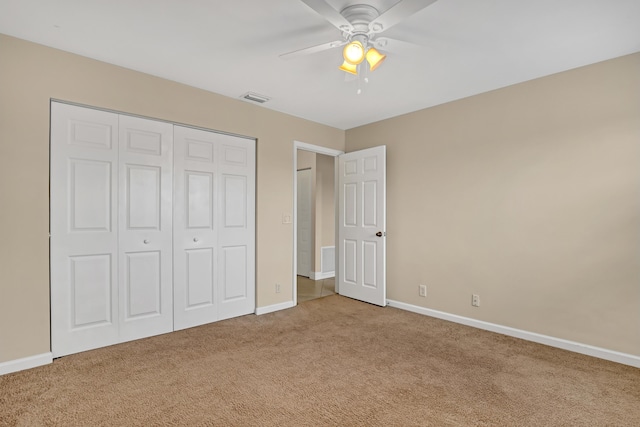 unfurnished bedroom with ceiling fan, a closet, and carpet floors